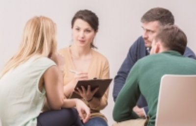 female psychologist during meeting with a support group for workaholics