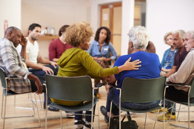 people attending self help therapy group meeting