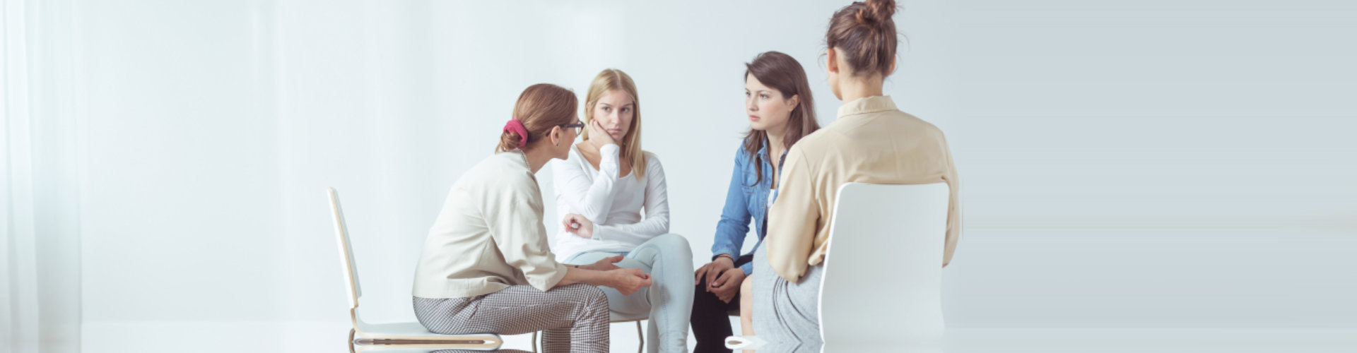 women sitting in circle during session with psychologist