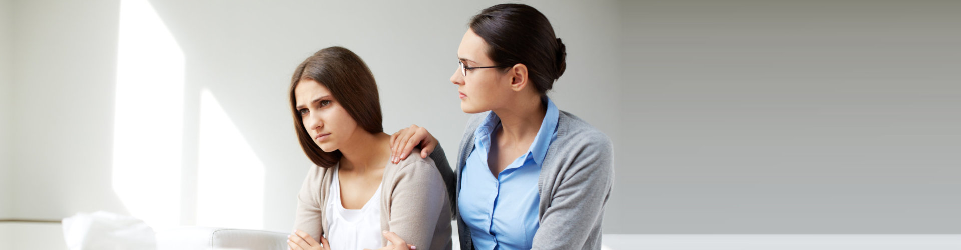 young psychiatrist comforting depressed woman